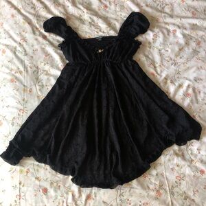 Black floral asymmetrical mesh babydoll dress with rose detail